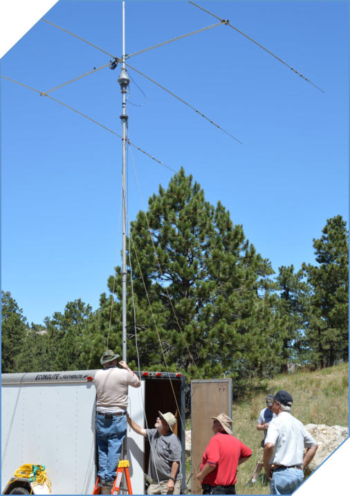 Image
                                of club members assembling an antenna
                                attached to a trailer